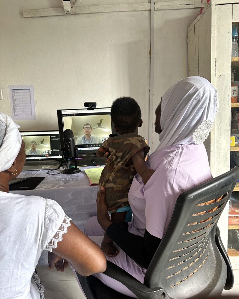 A nurse and mother with a baby on a video consultation with a physician